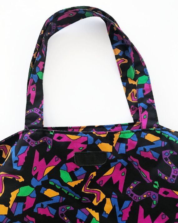Fruit Vintage 1980s Missoni beach bag in a psychedelic logo printed nylon fabric. Features a zipper closure at top and internal zipped pocket.