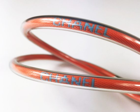 Fruit Vintage Chanel orange wrap around rubber tubing choker with CHANEL text logo all around.