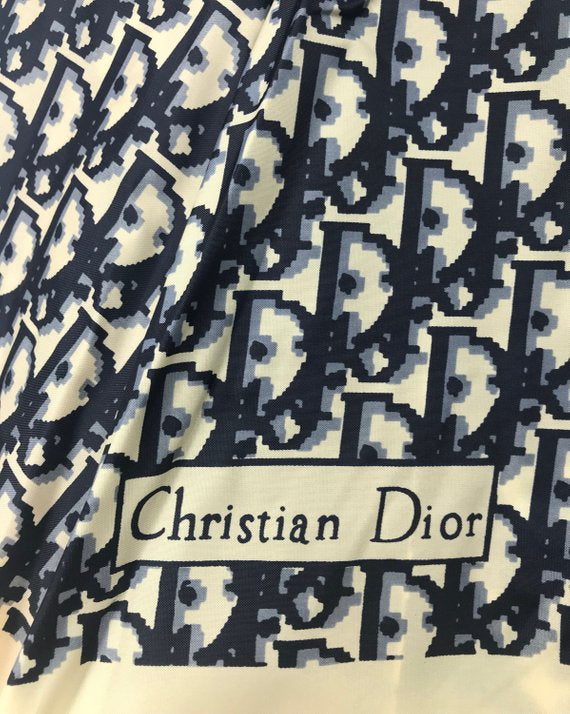 FRUIT vintage Christian Dior navy oblique logo umbrella dating to the late 1970s-early 1980s. This compact umbrella is in working condition with a matching cover, features the classic Christian Dior trotter/oblique print all over, Christian Dior logo text, telescoping stick and faux wood handle.