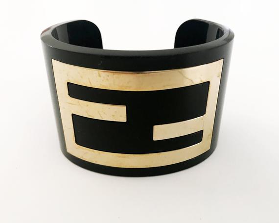 FRUIT Vintage Fendi Zucca Monogram Logo Cuff Bracelet. Featuring large brass Fendi logo F's set in black perspex.