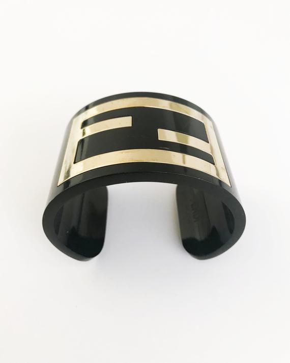 FRUIT Vintage Fendi Zucca Monogram Logo Cuff Bracelet. Featuring large brass Fendi logo F's set in black perspex.