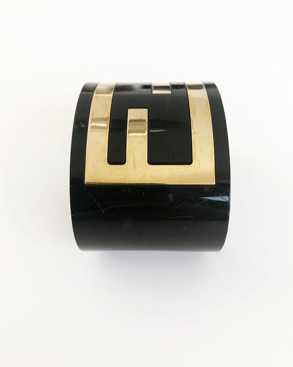 FRUIT Vintage Fendi Zucca Monogram Logo Cuff Bracelet. Featuring large brass Fendi logo F's set in black perspex.