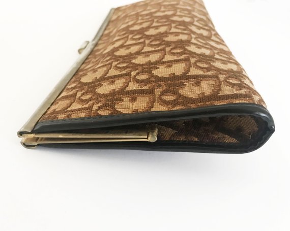 FRUIT vintage 1970s Christian Dior clutch bag is made of Brown oblique monogram logo trotter print canvas and features a gold hardware clip top closure.