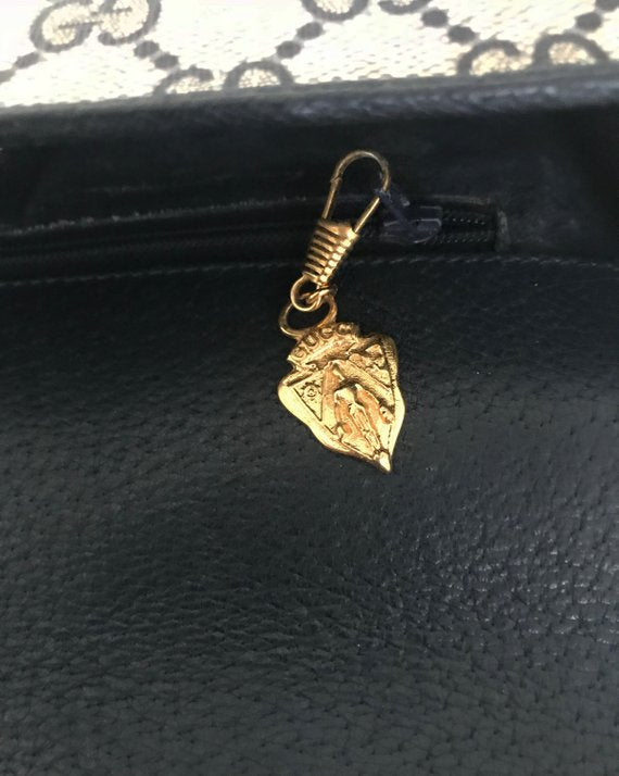 Fruit Vintage Gucci 1980s Logo embellished cross body satchel bag in a navy coated version of the classic Gucci monogram canvas.