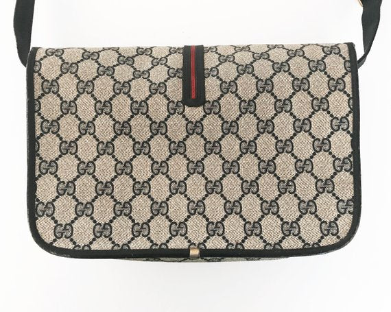 Fruit Vintage Gucci 1980s Logo embellished cross body satchel bag in a navy coated version of the classic Gucci monogram canvas.