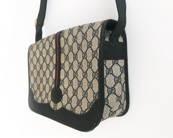 Fruit Vintage Gucci 1980s Logo embellished cross body satchel bag in a navy coated version of the classic Gucci monogram canvas.