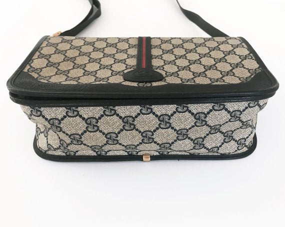 Fruit Vintage Gucci 1980s Logo embellished cross body satchel bag in a navy coated version of the classic Gucci monogram canvas.