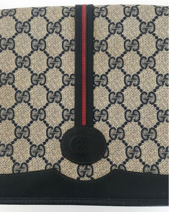Fruit Vintage Gucci 1980s Logo embellished cross body satchel bag in a navy coated version of the classic Gucci monogram canvas.