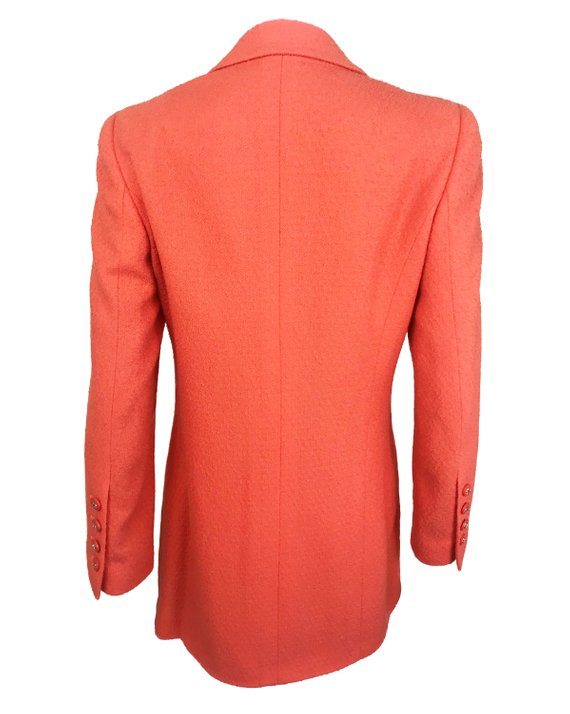 Fruit Vintage Chanel boucle jacket in pale neon peach tone. This jacket is from the famous Spring/Summer 1996 RTW collection by Karl Lagerfeld. It features a longer-line length, classic Chanel logo buttons, internal chain hem and two front pockets.