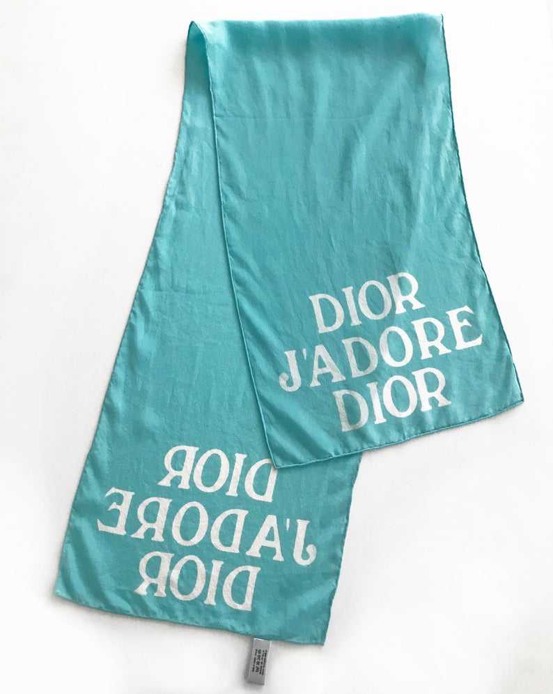 FRUIT vintage Christian Dior rare J'adore Dior logo monogram silk scarf perfect for use as a hair accessory, to tie around a hat or when worn around the neck. Features a bold graphic Dior logo print on both ends and hand finished rolled hem edging
