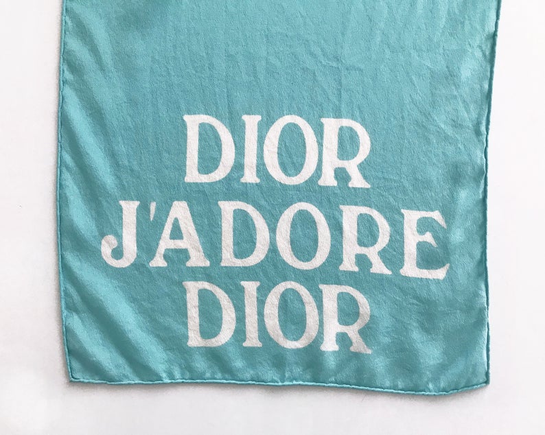 FRUIT vintage Christian Dior rare J'adore Dior logo monogram silk scarf perfect for use as a hair accessory, to tie around a hat or when worn around the neck. Features a bold graphic Dior logo print on both ends and hand finished rolled hem edging