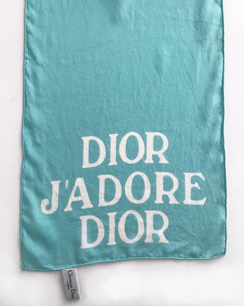 FRUIT vintage Christian Dior rare J'adore Dior logo monogram silk scarf perfect for use as a hair accessory, to tie around a hat or when worn around the neck. Features a bold graphic Dior logo print on both ends and hand finished rolled hem edging