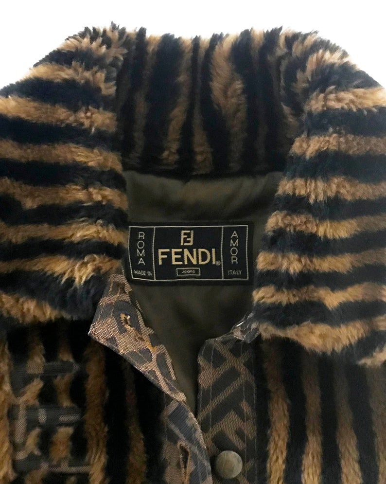 FRUIT Vintage Fendi faux fur stripe bomber jacket dating to 1995. It features the classic Zucca logo trim and embroidered Zucca print Fendi letters, as worn by Mary J Blige