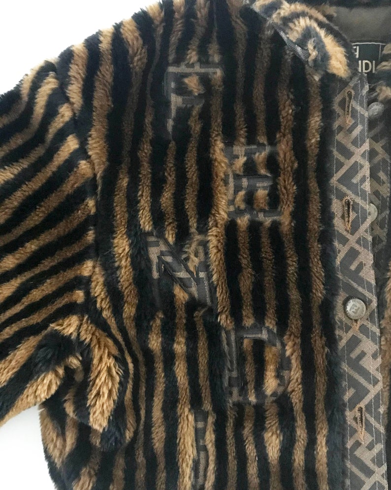 FRUIT Vintage Fendi faux fur stripe bomber jacket dating to 1995. It features the classic Zucca logo trim and embroidered Zucca print Fendi letters, as worn by Mary J Blige