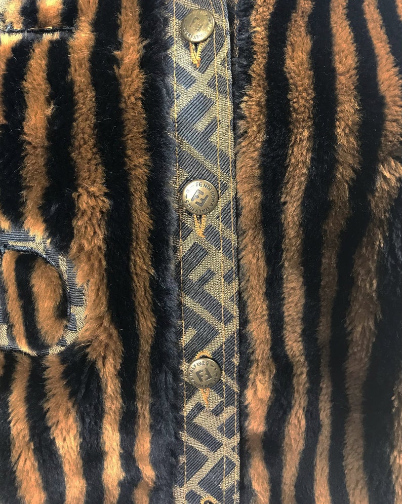 FRUIT Vintage Fendi faux fur stripe bomber jacket dating to 1995. It features the classic Zucca logo trim and embroidered Zucca print Fendi letters, as worn by Mary J Blige