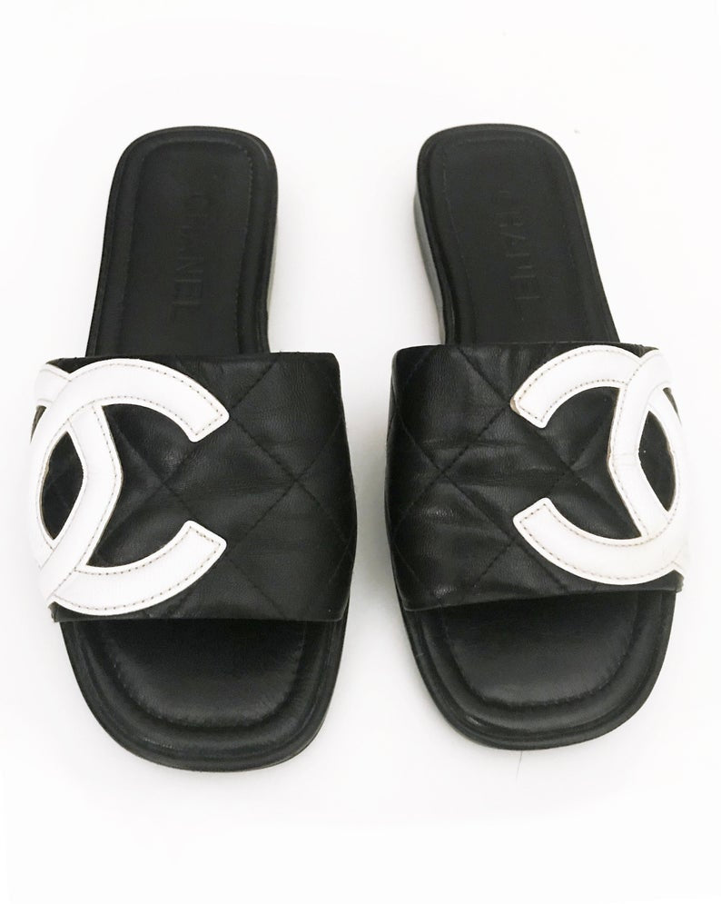 Fruit Vintage black Chanel logo slides with classic Chanel quilted leather with large CC monogram logos to the outer sides of each shoe.