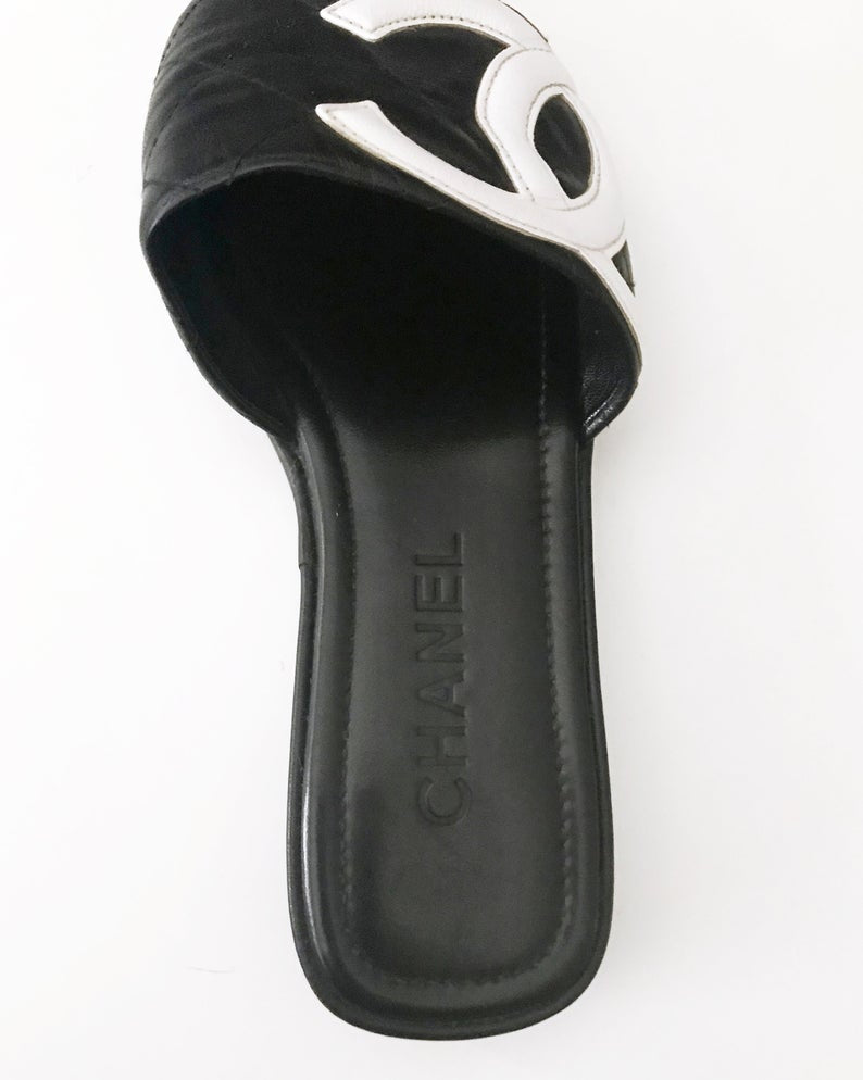 Fruit Vintage black Chanel logo slides with classic Chanel quilted leather with large CC monogram logos to the outer sides of each shoe.
