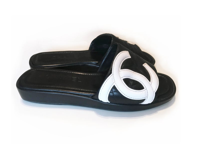 Fruit Vintage black Chanel logo slides with classic Chanel quilted leather with large CC monogram logos to the outer sides of each shoe.