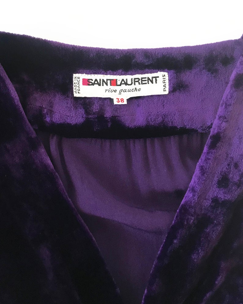 FRUIT Vintage Yves Saint Laurent Rive Gauche purple velvet gown dating to the 1970s. YSL dress features a plunging neckline, gorgeous 70s bell sleeves and removable wrap tie belt. It can be worn as a dress or unclipped and worn as a duster jacket/robe.