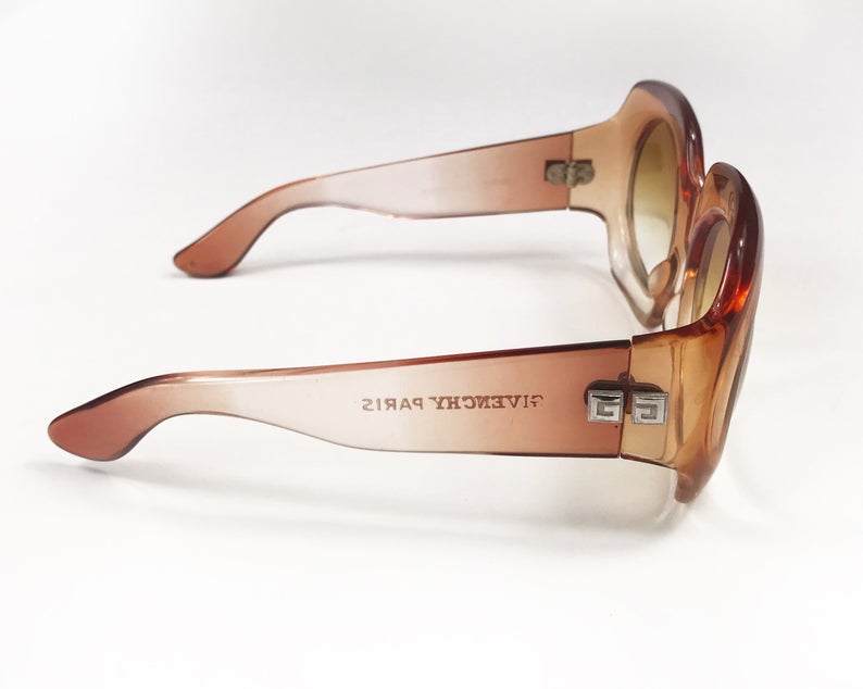 Fruit Vintage Givenchy Paris oversized vintage sunglasses dating to the 1970s. Comes with original suede case. Hand made, they feature Givenchy G logos on each arm and brown ombre lenses.