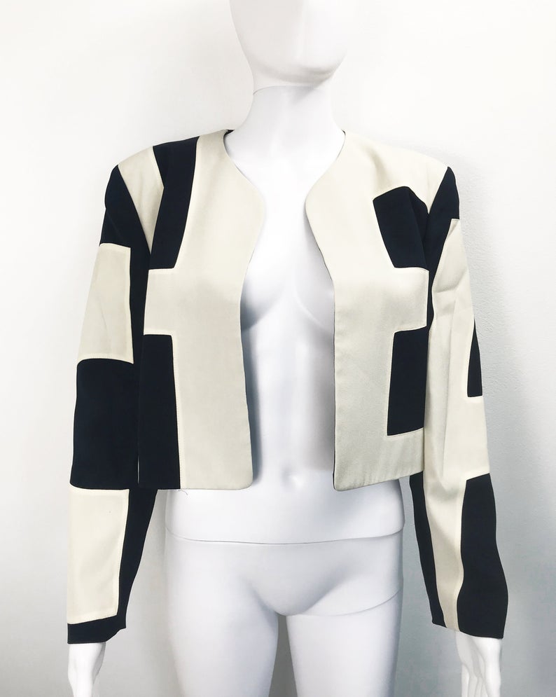 FRUIT Vintage rare and collectable Moschino Cheap & Chic logo slogan jacket dating to the 1990s. Cut for a cropped, boxy fit, it features a large, graphic, block letter design of the words 'CHEAP' with 'and Chic' embroidered at the rear.