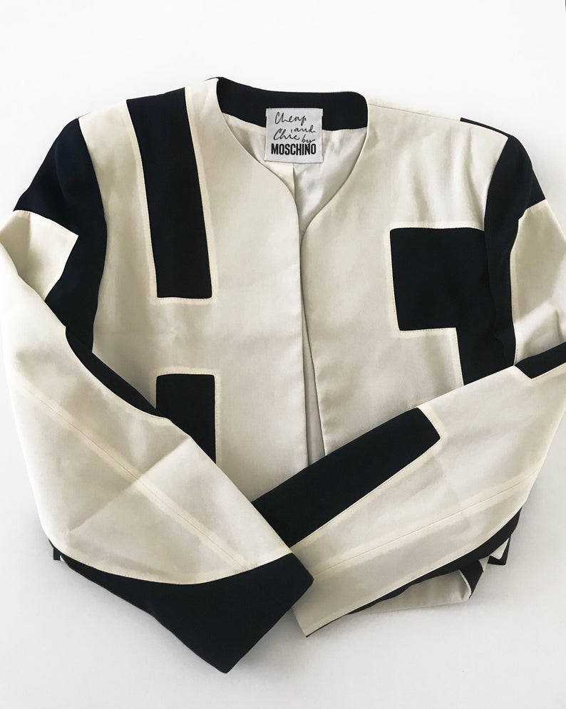 FRUIT Vintage rare and collectable Moschino Cheap & Chic logo slogan jacket dating to the 1990s. Cut for a cropped, boxy fit, it features a large, graphic, block letter design of the words 'CHEAP' with 'and Chic' embroidered at the rear.