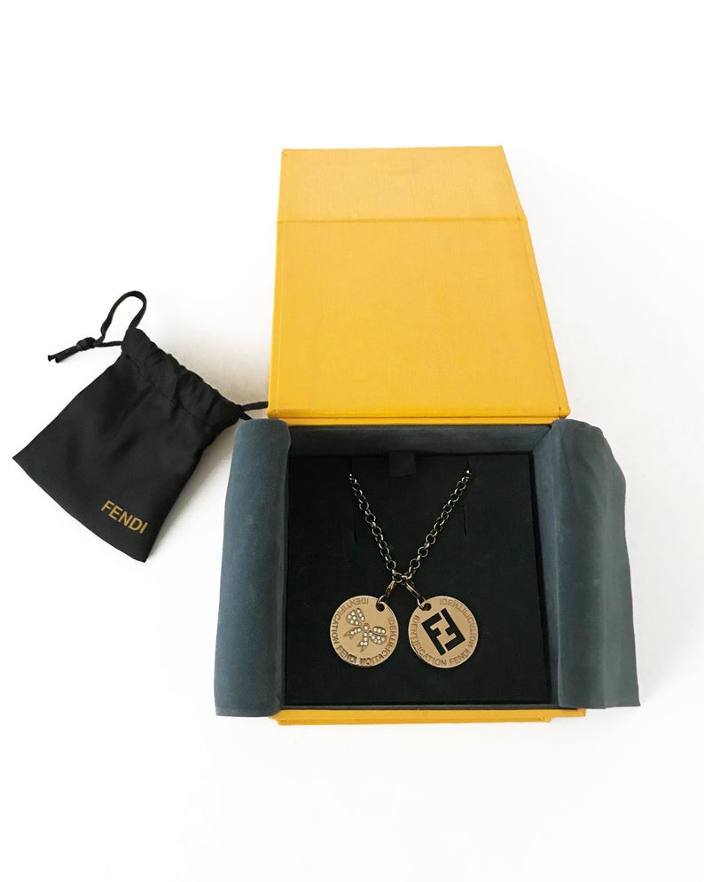 FRUIT Vintage Fendi zucca logo charm necklace in excellent condition. Features 2 removable charm pendants, one with cut-out Fendi logo F's and a second with crystal embellished bow symbol