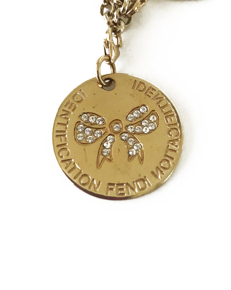 FRUIT Vintage Fendi zucca logo charm necklace in excellent condition. Features 2 removable charm pendants, one with cut-out Fendi logo F's and a second with crystal embellished bow symbol