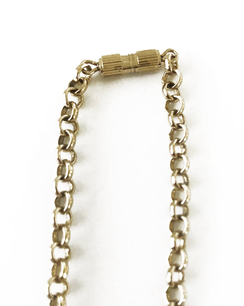 FRUIT Vintage Fendi zucca logo charm necklace in excellent condition. Features 2 removable charm pendants, one with cut-out Fendi logo F's and a second with crystal embellished bow symbol