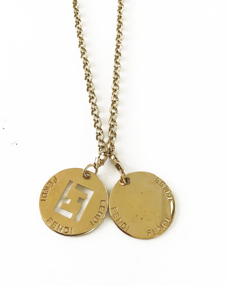 FRUIT Vintage Fendi zucca logo charm necklace in excellent condition. Features 2 removable charm pendants, one with cut-out Fendi logo F's and a second with crystal embellished bow symbol