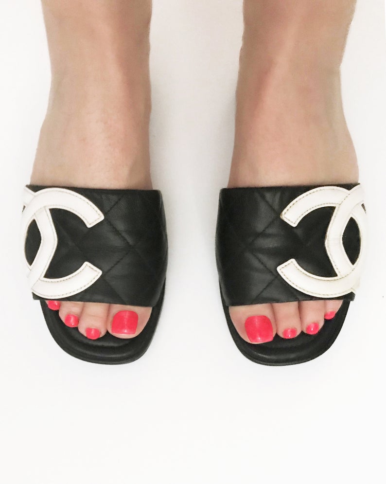 Fruit Vintage black Chanel logo slides with classic Chanel quilted leather with large CC monogram logos to the outer sides of each shoe.