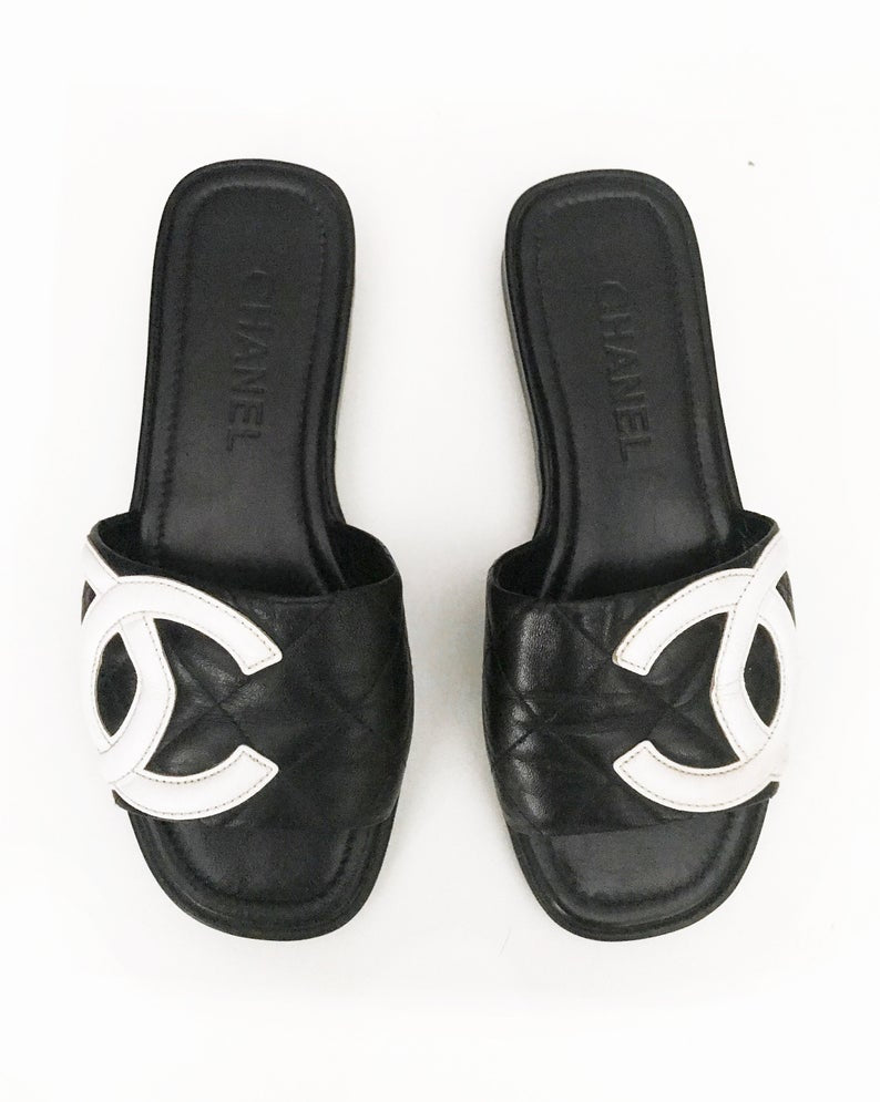 Fruit Vintage black Chanel logo slides with classic Chanel quilted leather with large CC monogram logos to the outer sides of each shoe.