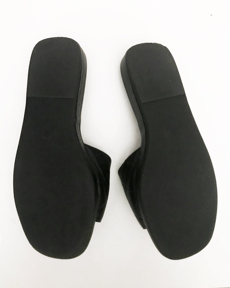 Fruit Vintage black Chanel logo slides with classic Chanel quilted leather with large CC monogram logos to the outer sides of each shoe.