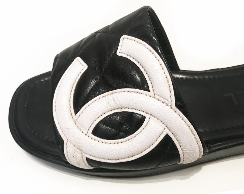 Fruit Vintage black Chanel logo slides with classic Chanel quilted leather with large CC monogram logos to the outer sides of each shoe.
