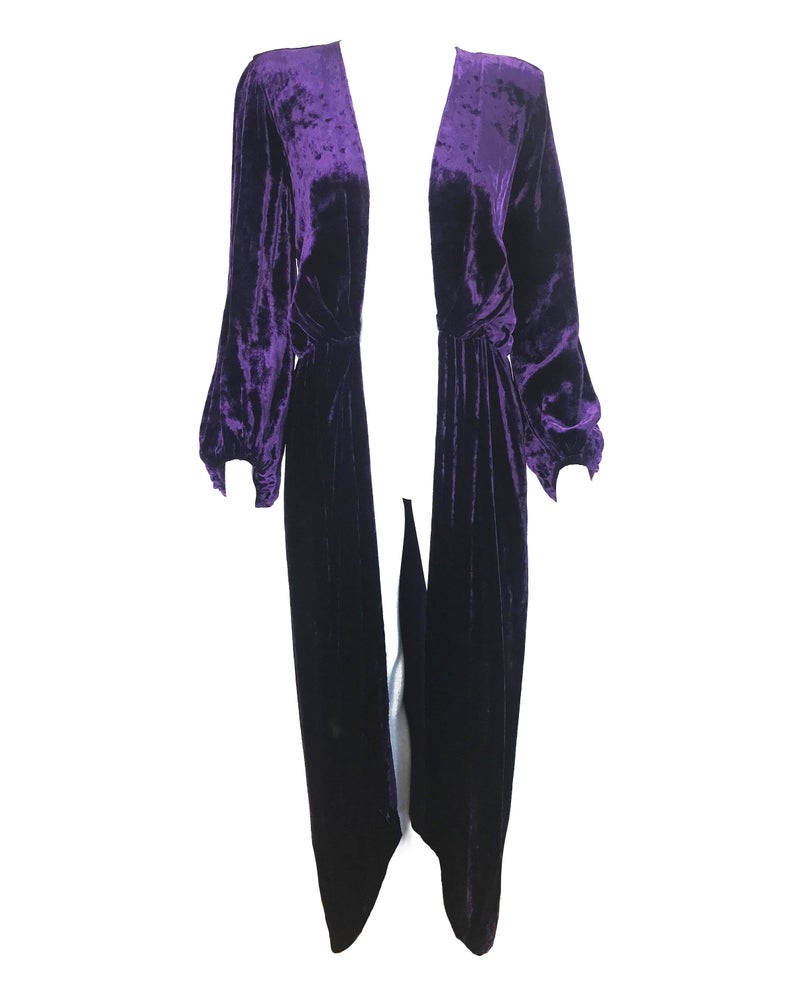 FRUIT Vintage Yves Saint Laurent Rive Gauche purple velvet gown dating to the 1970s. YSL dress features a plunging neckline, gorgeous 70s bell sleeves and removable wrap tie belt. It can be worn as a dress or unclipped and worn as a duster jacket/robe.