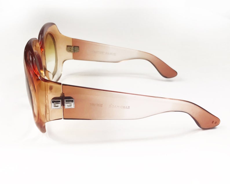 Fruit Vintage Givenchy Paris oversized vintage sunglasses dating to the 1970s. Comes with original suede case. Hand made, they feature Givenchy G logos on each arm and brown ombre lenses.