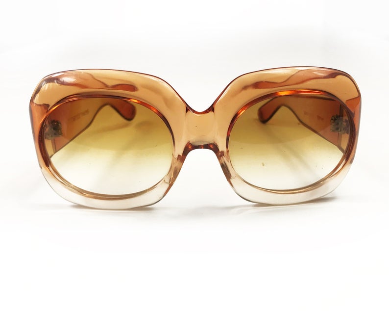 Fruit Vintage Givenchy Paris oversized vintage sunglasses dating to the 1970s. Comes with original suede case. Hand made, they feature Givenchy G logos on each arm and brown ombre lenses.