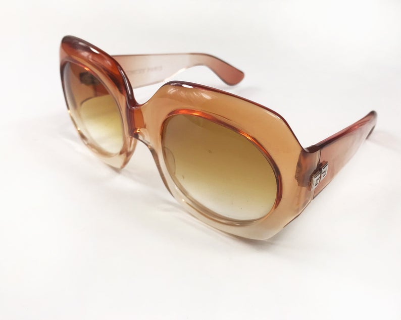 Fruit Vintage Givenchy Paris oversized vintage sunglasses dating to the 1970s. Comes with original suede case. Hand made, they feature Givenchy G logos on each arm and brown ombre lenses.