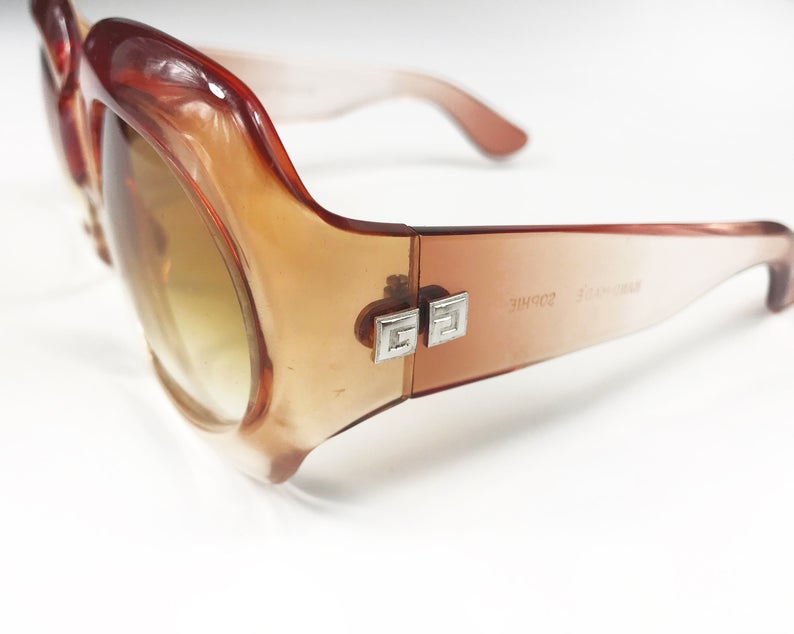 Fruit Vintage Givenchy Paris oversized vintage sunglasses dating to the 1970s. Comes with original suede case. Hand made, they feature Givenchy G logos on each arm and brown ombre lenses.