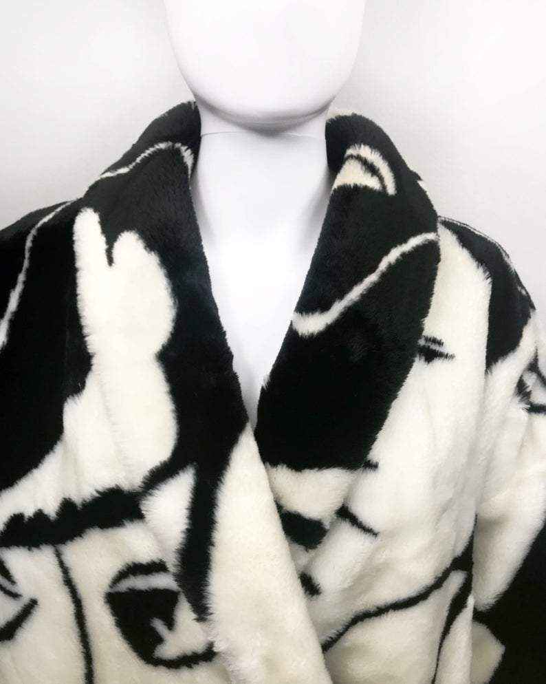 Fruit Vintage Donnybrook Faces Coat. Original 1980s Faux Fur cocoon coat with a relaxed, oversized silhouette. Features bold beige/black graphic custom Donnybrook face print.