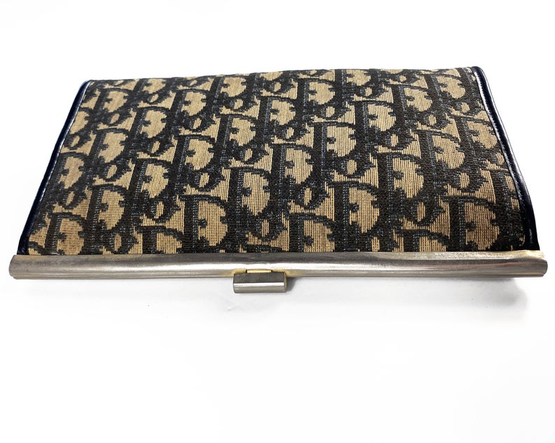 Fruit Vintage 1970s Christian Dior clutch bag with navy logo print canvas and featuring the iconic Dior 70's CD logo and gold hardware clip top closure