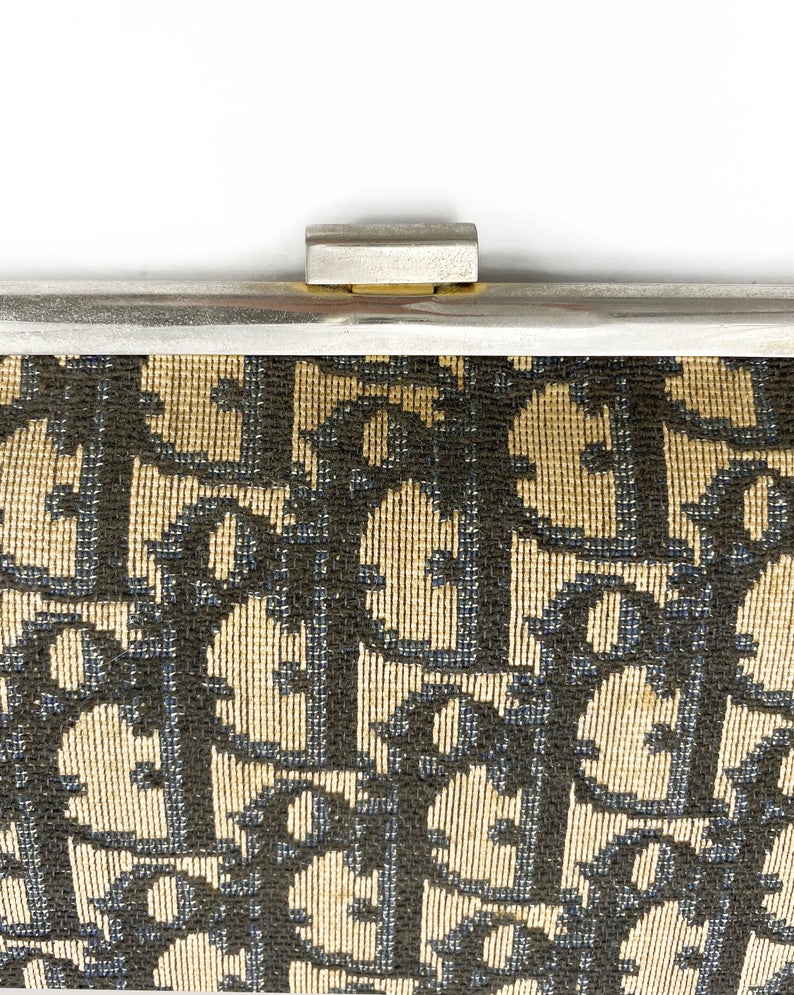 Fruit Vintage 1970s Christian Dior clutch bag with navy logo print canvas and featuring the iconic Dior 70's CD logo and gold hardware clip top closure