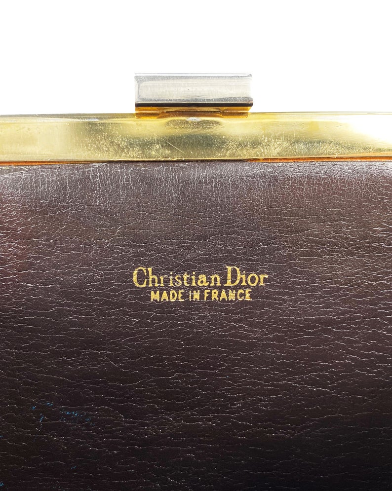 Fruit Vintage 1970s Christian Dior clutch bag with brown logo print canvas and featuring the iconic Dior 70's CD logo and gold hardware clip top closure