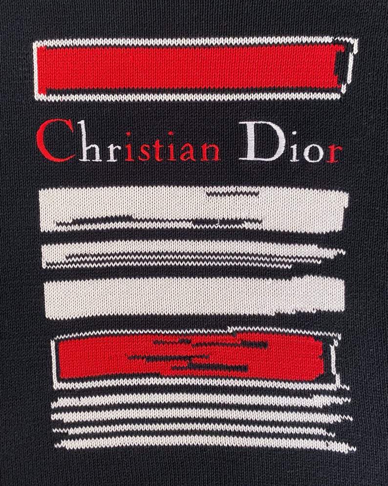 Fruit Vintage 1980s Christian Dior Sports Logo Knitted sweater. It features a large embroidered logo design at front and classic sweater knit cut.