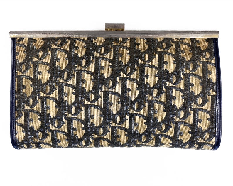 Fruit Vintage 1970s Christian Dior clutch bag with navy logo print canvas and featuring the iconic Dior 70's CD logo and gold hardware clip top closure
