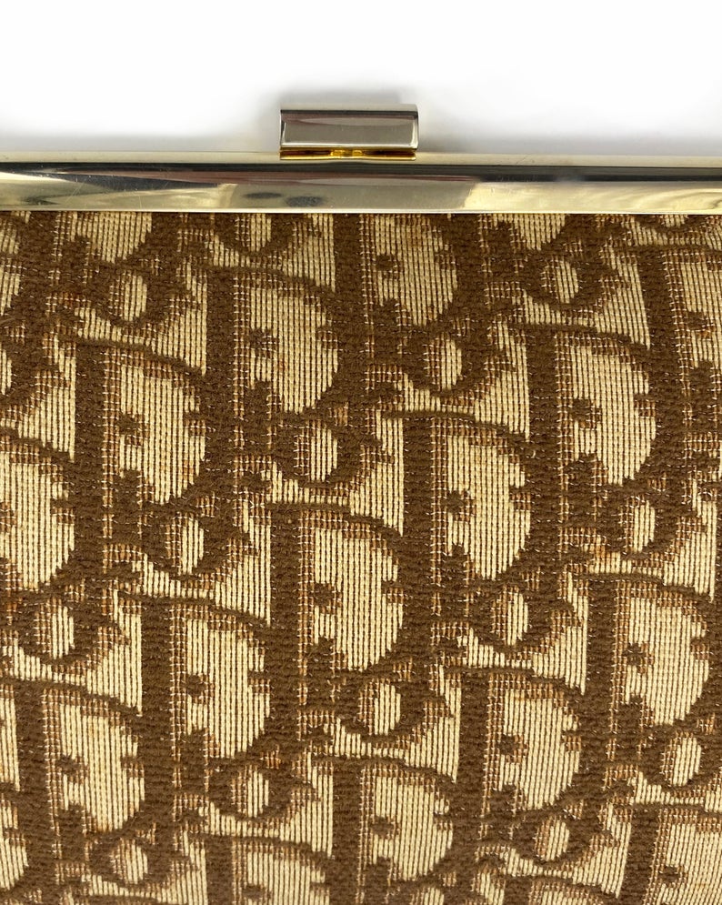 Fruit Vintage 1970s Christian Dior clutch bag with brown logo print canvas and featuring the iconic Dior 70's CD logo and gold hardware clip top closure
