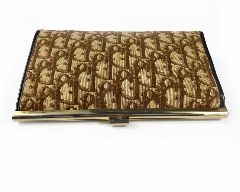Fruit Vintage 1970s Christian Dior clutch bag with brown logo print canvas and featuring the iconic Dior 70's CD logo and gold hardware clip top closure