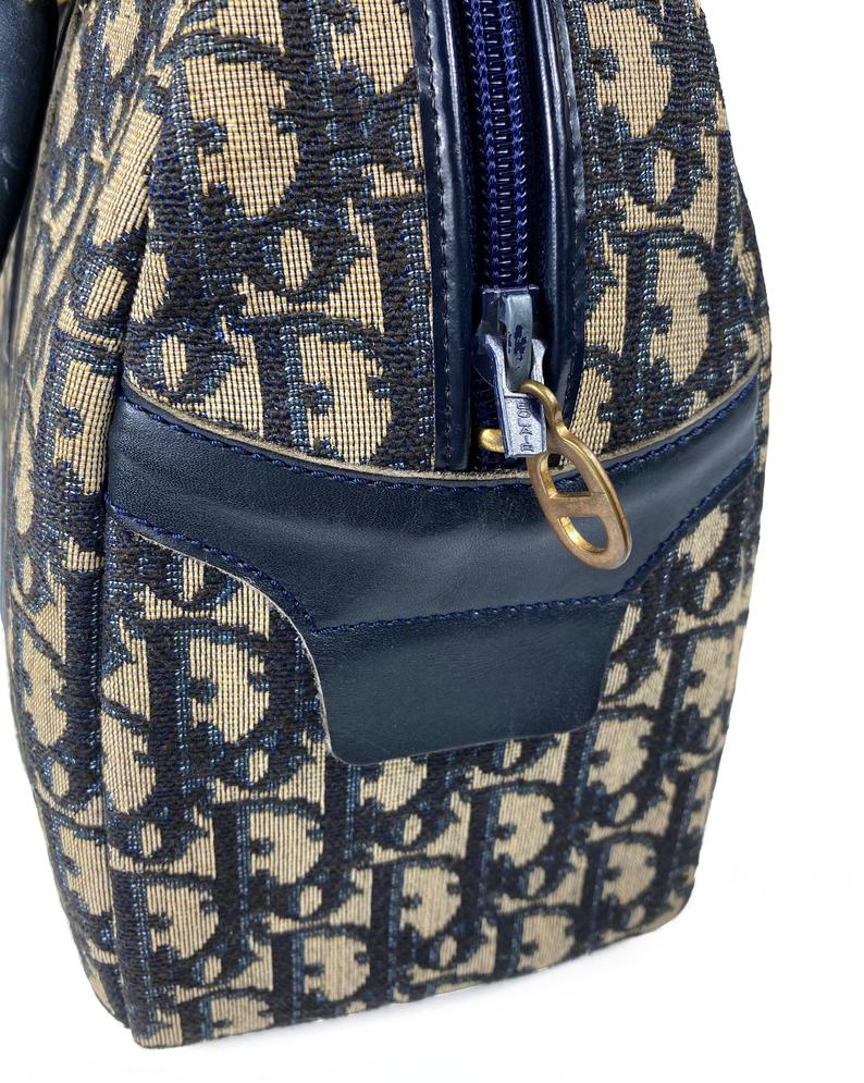 FRUIT Vintage 1970s Christian Dior navy monogram trotter oblique bowling bag. It features a large CD logo to the front, leather trim, 2 internal logo pockets and logo zipper pull.