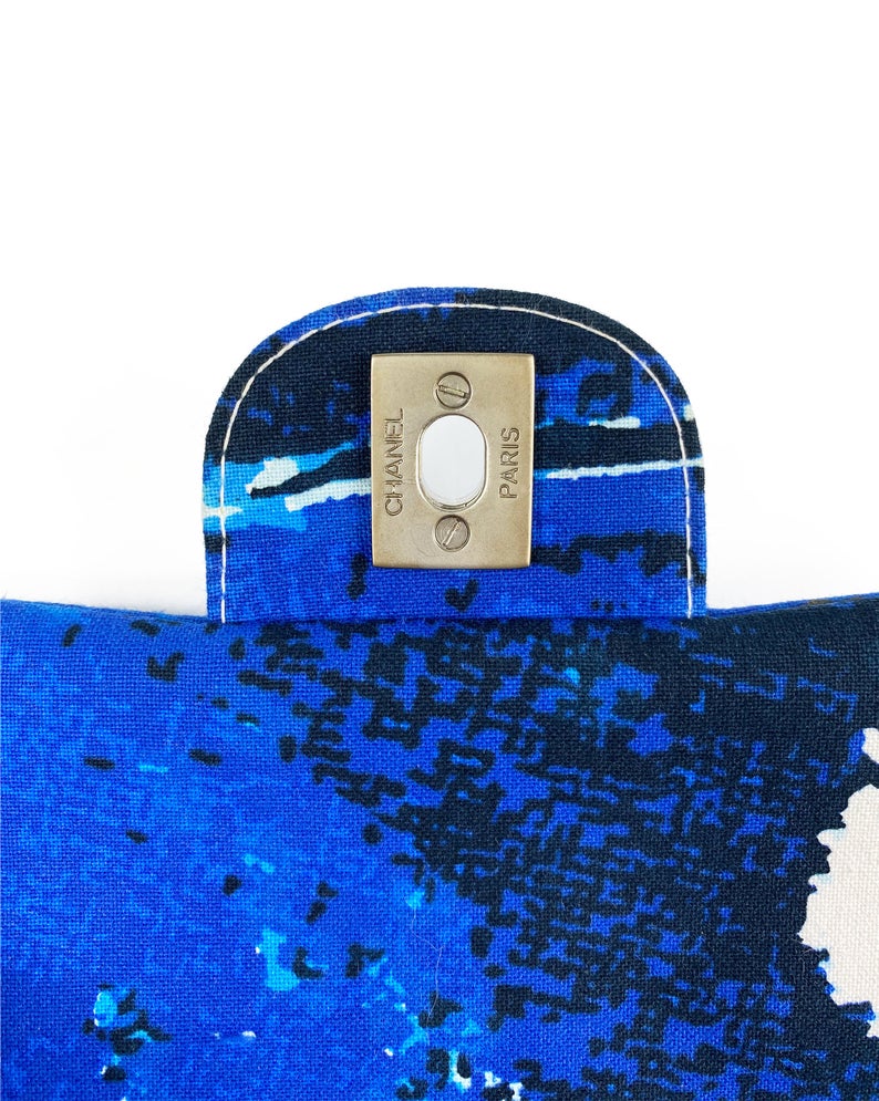 Fruit Vintage Chanel quilted surf print logo canvas flap bag. Features a graphic blue and white surf/wave print on canvas, a square quilted stitching design, classic Chanel flap and zipper closure with Chanel logo pull.