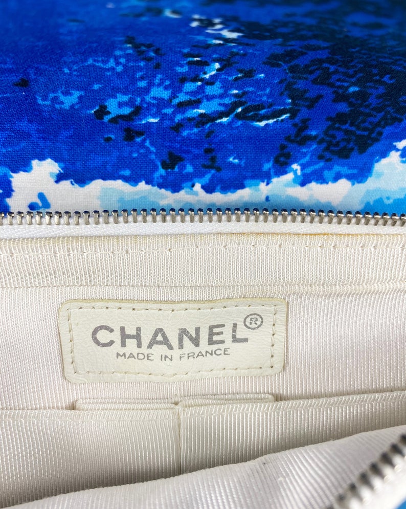 Fruit Vintage Chanel quilted surf print logo canvas flap bag. Features a graphic blue and white surf/wave print on canvas, a square quilted stitching design, classic Chanel flap and zipper closure with Chanel logo pull.
